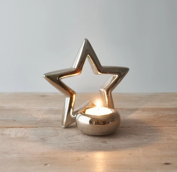 silver star tea light holder on a wooden table