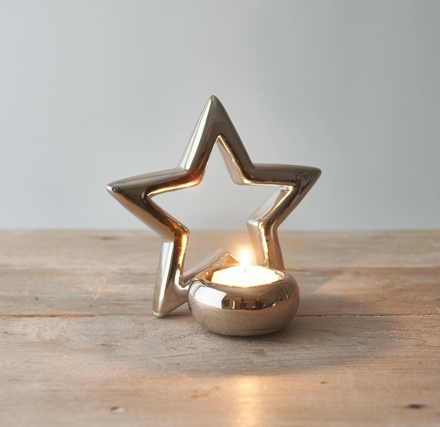 silver star tea light holder on a wooden table