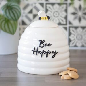 Bee Happy storage jar with biscuits piled next to it