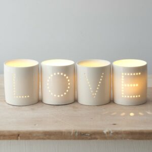 Love tea light holders on wooden table
